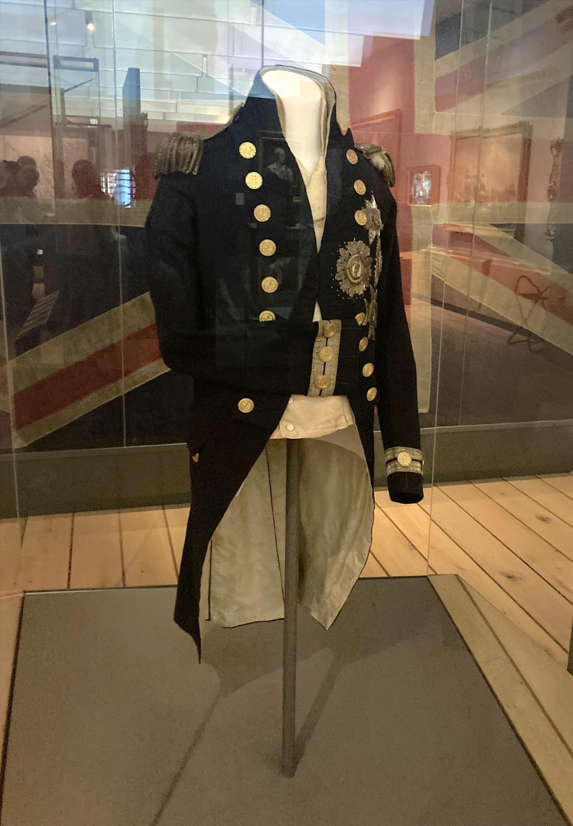 A Navy captain's coat in a museum display.