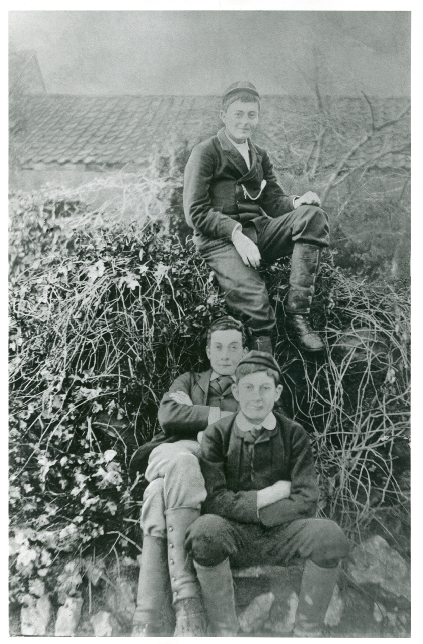 A black and white photograph of three boys in the Victorian era. 