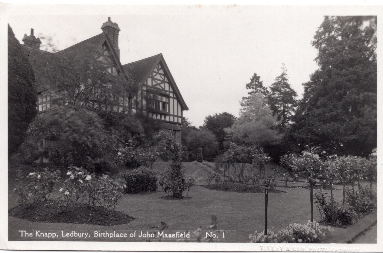 A large, timber framed building in a black and white landscape